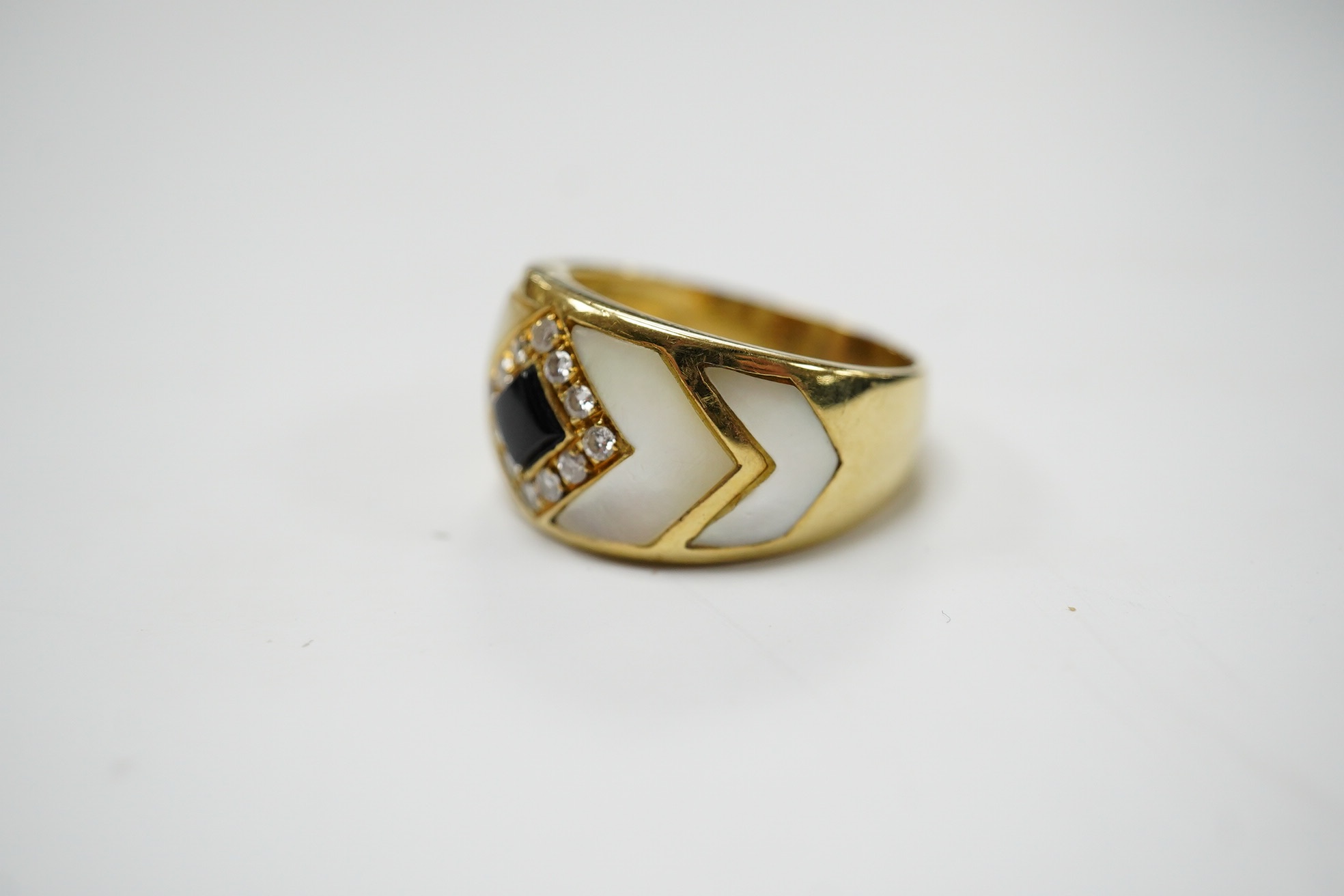 An Italian? yellow metal, mother of pearl, black enamel and diamond cluster set dress ring, size Q, gross weight 8.3 grams. Condition - fair